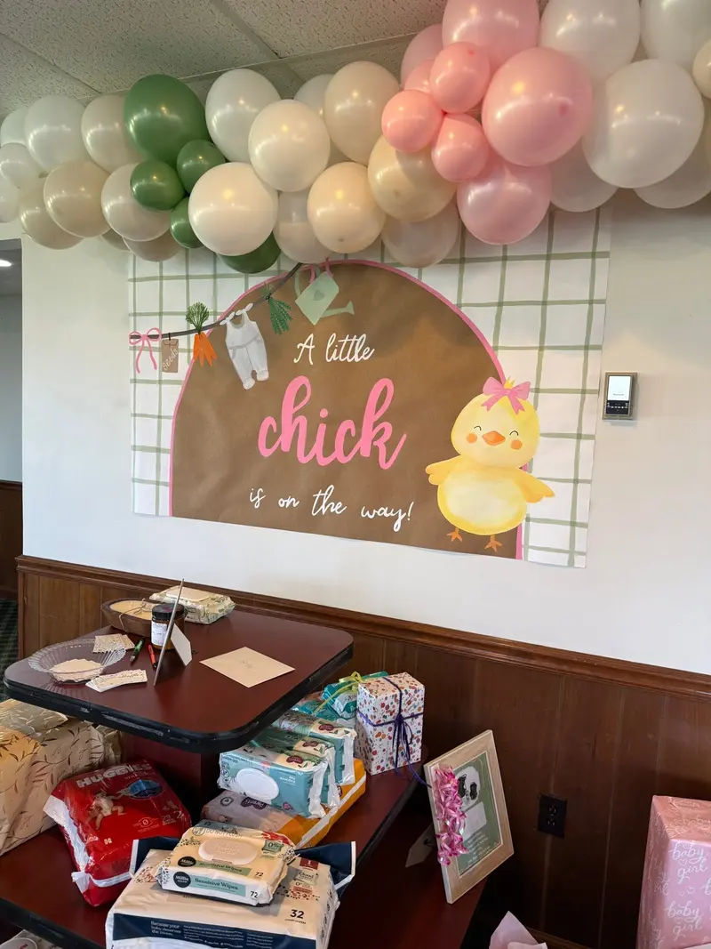 Pastel baby shower backdrop displayed in the venue's window room