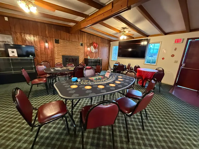 Casino-style tables arranged beneath the wood-beamed ceiling