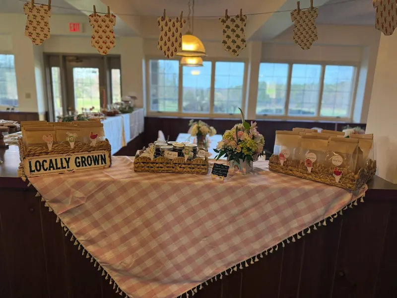 Farm-themed event display arranged in the bright window-lined room