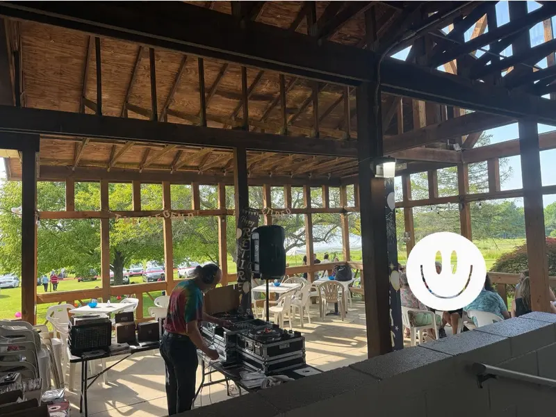 Open-air patio seating beneath the venue's dark wood roof