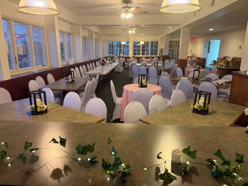 Pink-accented reception tables viewed from the venue's serving counter