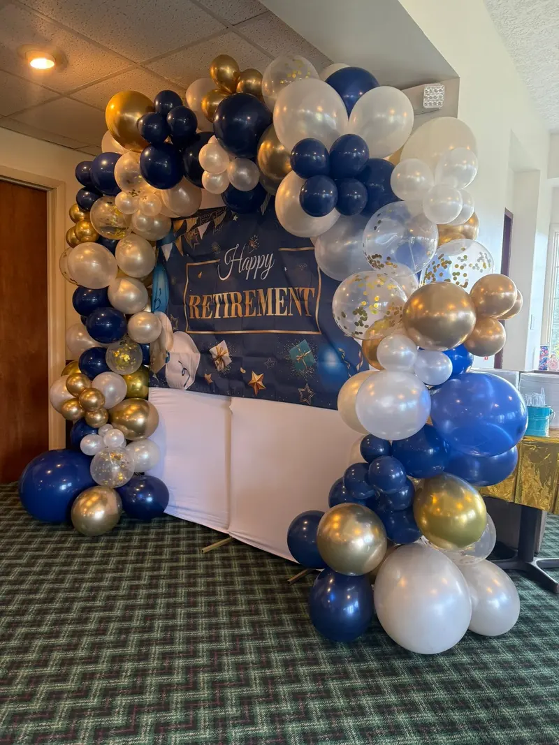 Blue, gold, and white balloon display for a retirement celebration
