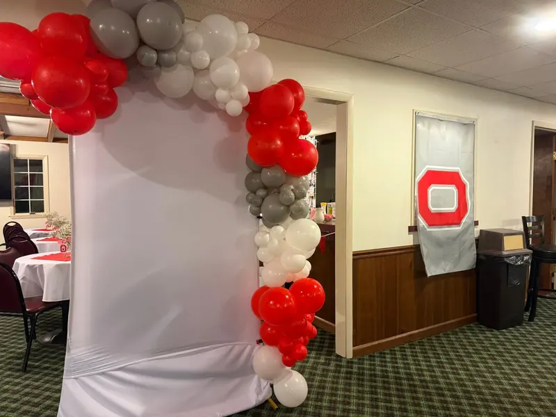Scarlet, gray, and white balloon arch for a graduation celebration