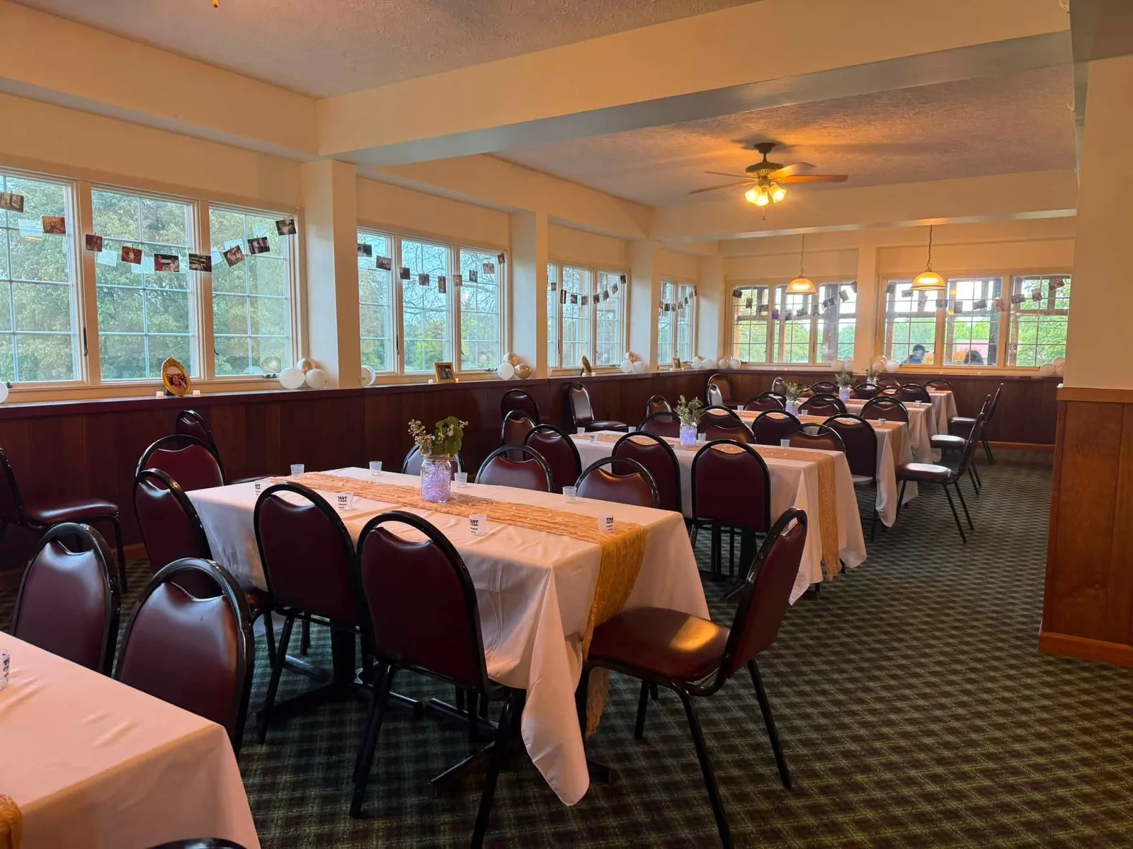 Reception seating surrounded by windows in Chapel Hill Venue's sunroom