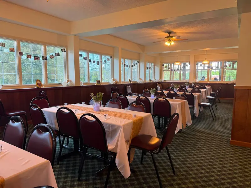 Reception seating surrounded by windows in Chapel Hill Venue's sunroom