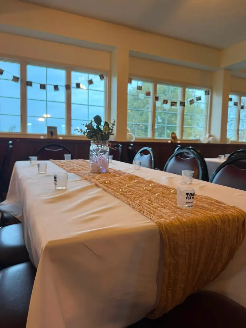 Sunlit windows and guest tables along the venue's enclosed porch